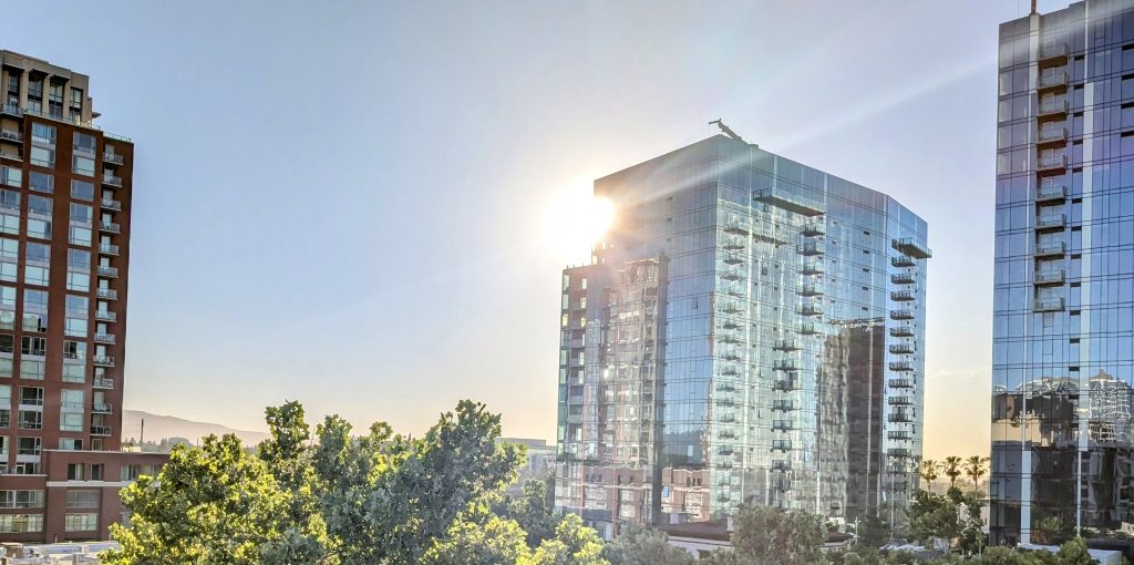 Glass office towers at sunset with clean reflective windows