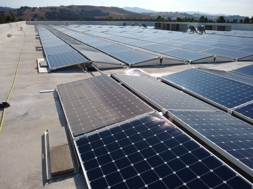 Shiny clean solar panels on a shingle roof