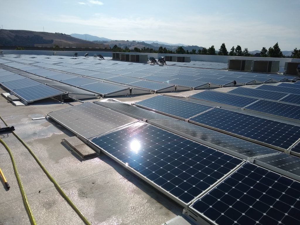 Dusty commercial rooftop solar panels before cleaning