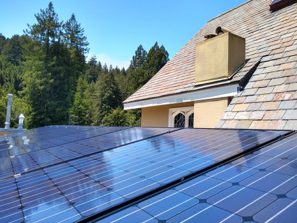 Rooftop solar panels with sun glare