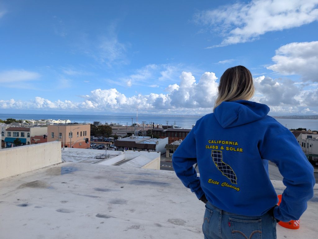 California Glass and Solar hoodie overlooking Monterey Bay from a rooftop